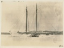 Image of Bowdoin in winter quarters with snowmobile alongside.`